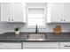 Kitchen sink with granite countertop and stainless steel faucet at 7771 Mattie Mccoy Ln, Winston, GA 30187
