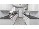Modern kitchen featuring white cabinets and granite countertops at 7771 Mattie Mccoy Ln, Winston, GA 30187