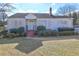 White single story house with red steps, landscaping, and a yard at 153 Hill St, Roswell, GA 30075