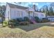 Front view of a charming white single story house with a yard at 153 Hill St, Roswell, GA 30075