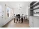 Bright dining area with a table set for four, lots of light, and wood-look flooring at 2425 Park Ave, Austell, GA 30106