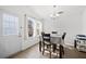 Bright dining area with a table set for four, lots of light, and wood-look flooring at 2425 Park Ave, Austell, GA 30106