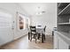 Bright dining area with a table set for four, lots of light, and wood-look flooring at 2425 Park Ave, Austell, GA 30106