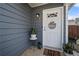 White front door with a welcome sign and potted plants at 2425 Park Ave, Austell, GA 30106