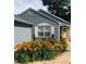 Charming home exterior with blue siding, a yellow front door, and colorful, mature landscaping at 2425 Park Ave, Austell, GA 30106