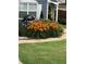 Landscaped front yard featuring lush green grass and a vibrant flower bed with various flowers near the house at 2425 Park Ave, Austell, GA 30106