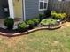 Landscaped yard featuring decorative brick edging, diverse plants, and small garden lights for evening ambiance at 2425 Park Ave, Austell, GA 30106