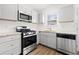 Updated kitchen features stainless steel appliances and granite countertops at 2425 Park Ave, Austell, GA 30106