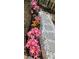 Landscaped pathway featuring colorful lilies alongside a stone paver walkway with decorative white rocks at 2425 Park Ave, Austell, GA 30106