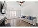 Open living room area with hardwood floors, fireplace, and gray sofa under a window at 2425 Park Ave, Austell, GA 30106