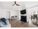 Open living room with fireplace, TV, ceiling fan, and dining room visible in the background at 2425 Park Ave, Austell, GA 30106