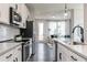 Modern kitchen with sleek countertops, stainless steel appliances and an open concept to the living area at 2656 Brookview Nw Ln, Atlanta, GA 30318