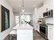 Stylish kitchen with stainless steel appliances, a large island with seating, and modern pendant lighting at 2656 Brookview Nw Ln, Atlanta, GA 30318