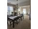 Dining room with a large table, chandelier, and adjacent living area at 730 Donner Ct, Mcdonough, GA 30252