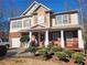 Two-story house with brick and siding, a porch, and landscaped yard at 730 Donner Ct, Mcdonough, GA 30252
