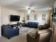 Spacious living room featuring comfortable seating and a large TV at 730 Donner Ct, Mcdonough, GA 30252