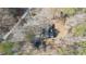 An aerial view shows a home with driveway surrounded by mature trees and natural landscaping at 85 Sara Dr, Covington, GA 30016
