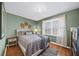 Comfortable bedroom featuring a queen bed, soft natural light, and neutral walls with attractive wall decor at 85 Sara Dr, Covington, GA 30016