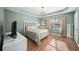 Bright bedroom with wood floors, tray ceiling, modern lighting, neutral walls, and a large window with natural light at 85 Sara Dr, Covington, GA 30016