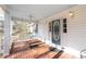 Inviting front porch featuring a porch swing and brick flooring at 85 Sara Dr, Covington, GA 30016