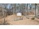 Well-maintained shed on a lot with mature trees and partial fence at 85 Sara Dr, Covington, GA 30016