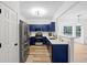 Modern kitchen with blue cabinets, stainless steel appliances, and quartz countertops at 132 Timber Mist Ln, Lawrenceville, GA 30045