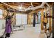 Unfinished basement with home gym setup and garage access at 2020 Temple Johnson Rd, Loganville, GA 30052