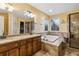 Elegant bathroom with double vanity, jetted tub, and walk-in shower at 2020 Temple Johnson Rd, Loganville, GA 30052