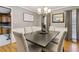 Bright dining room features hardwood floors and a spacious table with seating for six at 2020 Temple Johnson Rd, Loganville, GA 30052