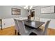 Formal dining room features hardwood floors, chandelier and kitchen view at 2020 Temple Johnson Rd, Loganville, GA 30052