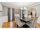 Spacious dining room with hardwood floors, chandelier, and view into adjacent rooms at 2020 Temple Johnson Rd, Loganville, GA 30052