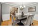 Elegant dining room with hardwood floors, chandelier, and staircase view at 2020 Temple Johnson Rd, Loganville, GA 30052
