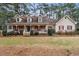 Two-story house with a wraparound porch and landscaped yard at 2020 Temple Johnson Rd, Loganville, GA 30052