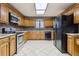 Kitchen features wood cabinets, granite countertops, and stainless steel appliances at 2020 Temple Johnson Rd, Loganville, GA 30052