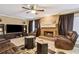 Spacious living room featuring a fireplace and ceiling fan at 2020 Temple Johnson Rd, Loganville, GA 30052