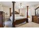 Spacious main bedroom with a large four poster bed and en-suite bathroom at 2020 Temple Johnson Rd, Loganville, GA 30052
