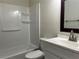 Updated bathroom with a shower/tub combo and white vanity at 5950 Wintergreen Rd, Norcross, GA 30093