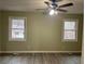 Bright bedroom with two windows and ceiling fan at 5950 Wintergreen Rd, Norcross, GA 30093