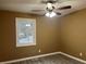 Well-lit bedroom with ceiling fan and wood-look flooring at 5950 Wintergreen Rd, Norcross, GA 30093