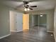 Bedroom with mirrored closet doors and ceiling fan at 5950 Wintergreen Rd, Norcross, GA 30093