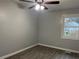 Spacious bedroom with ceiling fan and large window at 5950 Wintergreen Rd, Norcross, GA 30093