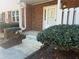 Inviting front entrance with concrete steps, brick facade, and green shrubbery at 5950 Wintergreen Rd, Norcross, GA 30093