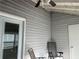 Exterior view of sunroom with ceiling fan and gray siding at 5950 Wintergreen Rd, Norcross, GA 30093