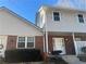 Two-story townhouse showcasing brick accents, neutral siding, and a well-manicured front yard at 5950 Wintergreen Rd, Norcross, GA 30093