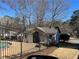 View of the pool house with benches within the fenced in area at 5950 Wintergreen Rd, Norcross, GA 30093