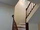 Indoor staircase with wooden railings and banister at 5950 Wintergreen Rd, Norcross, GA 30093