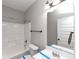 Clean bathroom with a shower/tub combo and white vanity at 7502 Springbox Dr, Fairburn, GA 30213