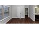 Bedroom with hardwood floors, neutral walls, and a view of the bathroom at 7502 Springbox Dr, Fairburn, GA 30213