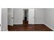Spacious bedroom with hardwood floors and neutral walls, two doors at 7502 Springbox Dr, Fairburn, GA 30213