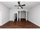 Spacious bedroom with dark hardwood floors and ceiling fan at 7502 Springbox Dr, Fairburn, GA 30213